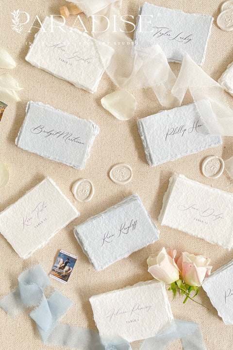 Add a touch of fine-art elegance to your celebration with our colored handmade paper place cards, crafted from premium cotton rag paper and finished with soft, natural deckled edges. Each card features beautifully flowing calligraphy and comes in a curated palette of soft, romantic hues - perfect for weddings, dinner parties, bridal showers, or luxury events. Designed to elevate any tablescape, these artisanal place cards bring warmth, texture, and timeless beauty to your seating arrangements.