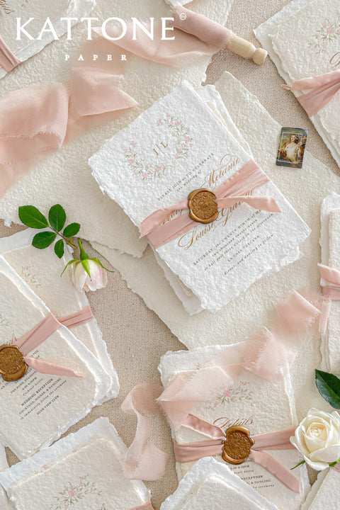 Announce your special day with the delicate, romantic charm of these handmade wedding invites. Perfect for a summer wedding, this suite features a soft and beautiful dusty pink color palette and delicate floral artwork. Each invitation is individually crafted, giving it a unique, tactile feel that you and your guests will appreciate. The combination of handcrafted artistry and a fresh, romantic design sets a beautiful tone for your celebration.