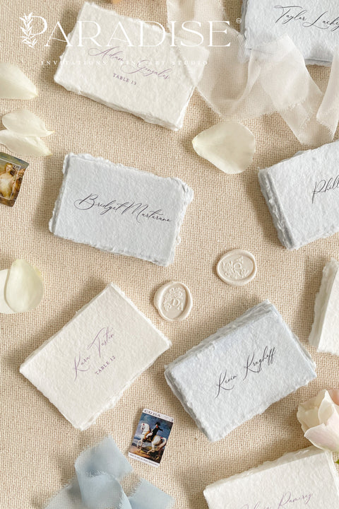 Add a touch of fine-art elegance to your celebration with our colored handmade paper place cards, crafted from premium cotton rag paper and finished with soft, natural deckled edges. Each card features beautifully flowing calligraphy and comes in a curated palette of soft, romantic hues - perfect for weddings, dinner parties, bridal showers, or luxury events. Designed to elevate any tablescape, these artisanal place cards bring warmth, texture, and timeless beauty to your seating arrangements.