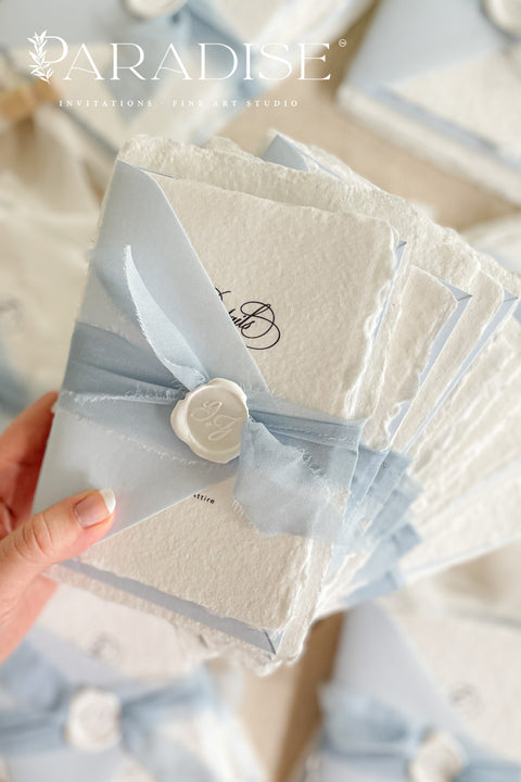 Announce your special day with a touch of coastal elegance and bohemian chic with this unique beach wedding invitations suite. Perfect for a seaside celebration, this elegant wedding stationery set combines classic details with a relaxed feel. Each invite is finished with a personalized wax seal, adding a luxurious, tactile element that makes a memorable first impression.