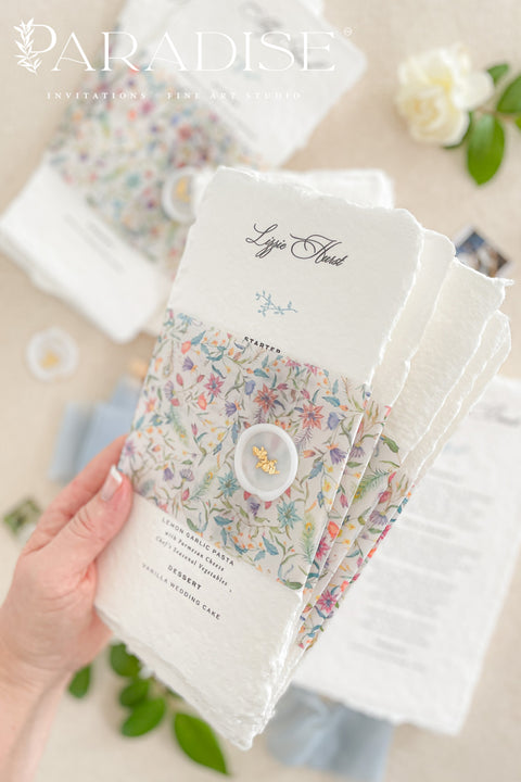 Add a touch of botanical beauty and fine art elegance to your event with our handmade paper wedding menus, crafted from 100% cotton rag paper with delicately torn deckled edges. Each menu features a vibrant floral vellum wrap paired with a soft silk ribbon and wax seal, creating an exquisite balance between organic texture and romantic detail. The minimalist typography allows the floral design to shine, making these menus perfect for garden weddings, spring celebrations and outdoor receptions.