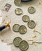 Bring a refined botanical accent to your stationery with these handcrafted botanical wax seals, finished in a soft sage-green ivory tone and delicately embellished with gold leaf. Each seal is individually poured and stamped, creating organic edges and subtle variations that celebrate true artisanal craftsmanship. Designed to complement fine-art paper, neutral palettes, and nature-inspired weddings, these wax seals add an elevated, timeless touch to invitations, envelopes, and curated details.