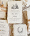 Handmade paper wedding invitations with custom church illustration, deckle edges, silk ribbon, and wax seal details.