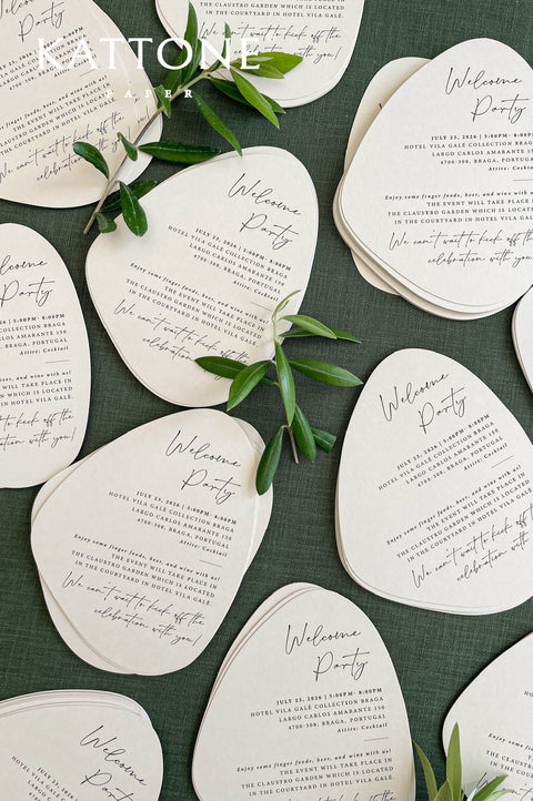 Close-up of handmade cotton paper wedding invitation featuring textured deckle edges and refined modern typography.