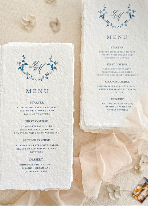 Celebrate refined elegance with our handmade paper menus featuring a floral monogram, meticulously printed on luxury cotton paper with natural deckled edges. The delicate botanical wreath paired with elegant typography evokes timeless romance - perfect for fine-art, garden, or European-inspired weddings. Each menu brings an heirloom quality to your tablescape, effortlessly blending sophistication and artisanal charm.