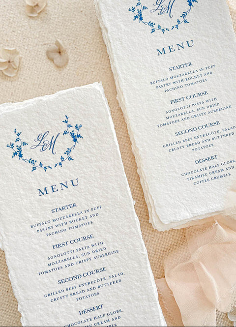 Celebrate refined elegance with our handmade paper menus featuring a floral monogram, meticulously printed on luxury cotton paper with natural deckled edges. The delicate botanical wreath paired with elegant typography evokes timeless romance - perfect for fine-art, garden, or European-inspired weddings. Each menu brings an heirloom quality to your tablescape, effortlessly blending sophistication and artisanal charm.
