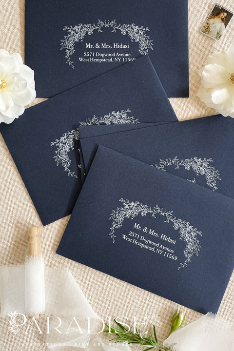 Navy wedding envelopes with white ink address printing, styled flat lay with ivory florals, wax seals, and greenery, perfect for classic and elegant invitation suites.