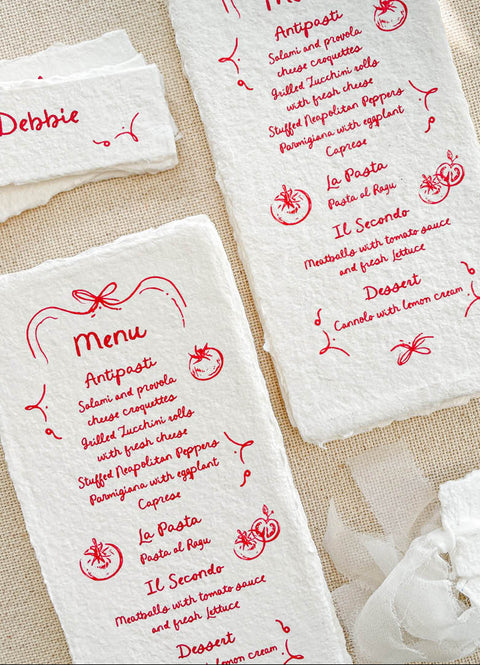 Infuse your tablescape with joyful artistry through our handmade paper menus with whimsical icons - a charming fusion of playfulness and elegance. Each piece is crafted on luxury cotton paper with soft deckled edges and illustrated with hand-drawn food and floral motifs in vivid ink. Perfect for Italian, rustic, or destination weddings, these menus bring warmth, creativity, and personality to your reception setting.