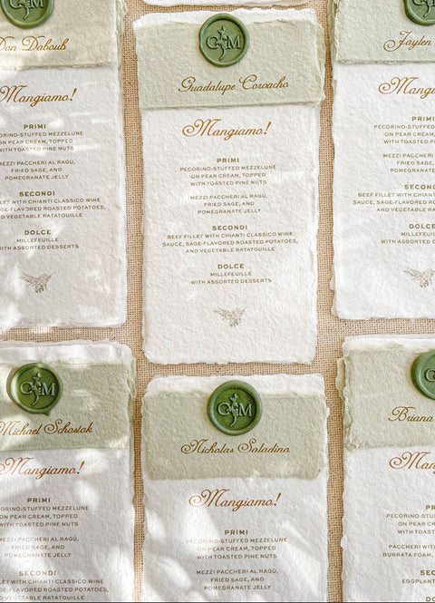 Elevate your wedding tablescape with our handmade paper menus, designed for timeless elegance and Italian-inspired charm. Each piece is printed on luxury cotton paper with natural deckled edges and features a personalized olive-green wax seal and matching paper band. The combination of fine typography and artisan textures brings warmth and sophistication to your table settings - perfect for fine-art, vineyard, or destination weddings.