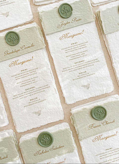 Elevate your wedding tablescape with our handmade paper menus, designed for timeless elegance and Italian-inspired charm. Each piece is printed on luxury cotton paper with natural deckled edges and features a personalized olive-green wax seal and matching paper band. The combination of fine typography and artisan textures brings warmth and sophistication to your table settings - perfect for fine-art, vineyard, or destination weddings.