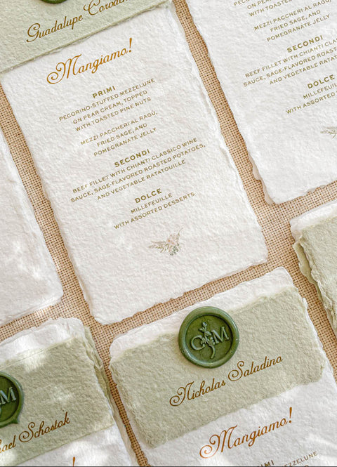 Elevate your wedding tablescape with our handmade paper menus, designed for timeless elegance and Italian-inspired charm. Each piece is printed on luxury cotton paper with natural deckled edges and features a personalized olive-green wax seal and matching paper band. The combination of fine typography and artisan textures brings warmth and sophistication to your table settings - perfect for fine-art, vineyard, or destination weddings.