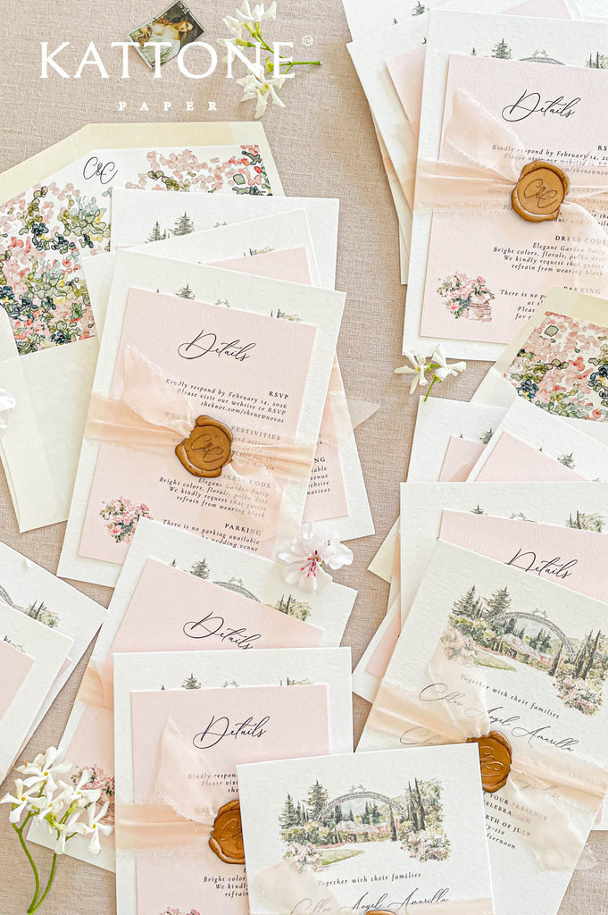 Stacked handmade paper wedding invitations and enclosure cards showcasing deckle edge texture and fine art venue illustration.