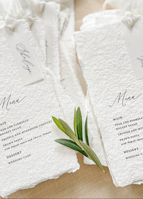 Add an ethereal touch to your wedding tables with our handmade paper menus with silk ribbons, crafted on luxury cotton paper with naturally deckled edges. Each piece features soft, hand-dyed silk chiffon ribbons and minimalist typography, blending refined simplicity with organic beauty. Perfect for romantic, fine-art, or garden weddings, these menus exude timeless charm and artisanal craftsmanship, setting the tone for a sophisticated celebration.