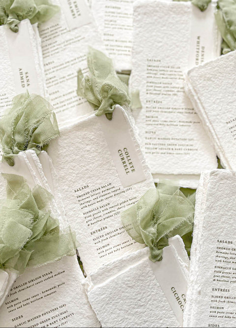 Add an ethereal touch to your wedding tables with our handmade paper menus with silk ribbons, crafted on luxury cotton paper with naturally deckled edges. Each piece features soft, hand-dyed silk chiffon ribbons and minimalist typography, blending refined simplicity with organic beauty. Perfect for romantic, fine-art, or garden weddings, these menus exude timeless charm and artisanal craftsmanship, setting the tone for a sophisticated celebration.