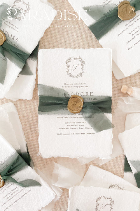 A refined christening invitation crafted from luxurious handmade paper and finished with rich green silk ribbon and a wax seal accent. Featuring a delicate botanical monogram and classic typography, this design beautifully balances tradition and elegance. Perfect for church christenings and baptisms, it creates a meaningful first impression and a timeless keepsake for your family.