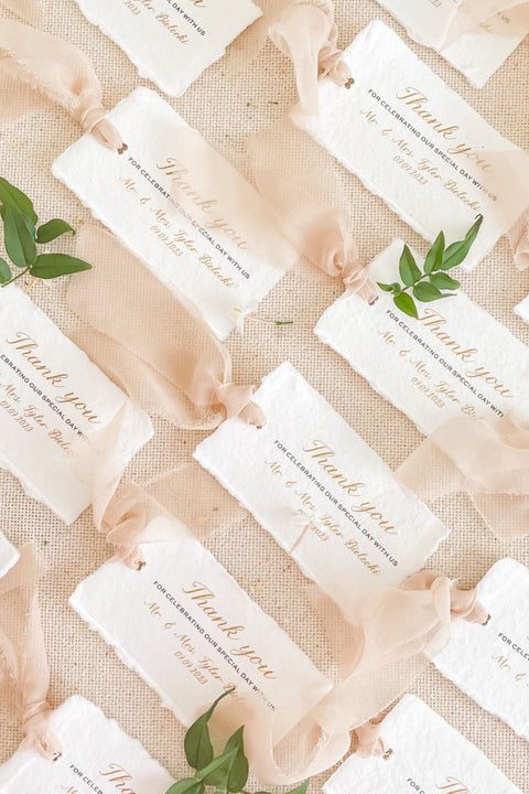 A beautifully handcrafted thank you card made from luxurious handmade paper, designed to express gratitude with timeless elegance. Featuring soft deckled edges, refined calligraphy-style typography, and an airy chiffon ribbon accent, these cards add a thoughtful, personal touch to weddings, events, and special occasions. Perfect for couples who appreciate fine-art stationery and meaningful details.