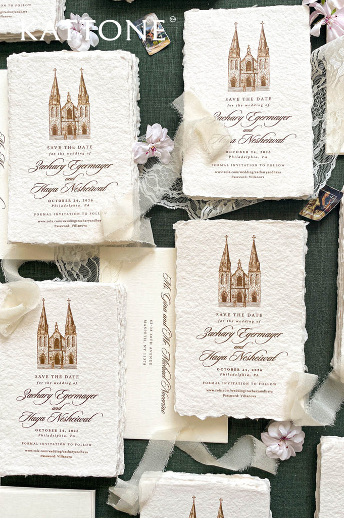 Flat lay of luxury save the date cards printed on handmade paper with a custom venue illustration.