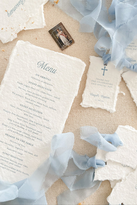 Celebrate your special occasion with our handmade paper place cards, crafted from luxurious cotton rag paper and finished with naturally torn deckled edges. Each card features soft blue lettering that pairs beautifully with baptism, christening, baby shower, and fine-art event themes. With their artisanal texture and elegant simplicity, these place cards add meaning, refinement, and timeless beauty to your table setting.