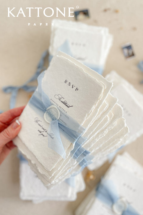 Announce your special day with understated elegance and personal charm. This earthen neutral wedding stationery collection is crafted to celebrate your love story with a refined, organic feel. Each invitation is a personalised handmade invite, featuring your unique details on our premium, artisan paper. The soft, neutral tones create a timeless and tranquil aesthetic, perfectly complemented by the gentle hue of the "Light Sky" accent color.