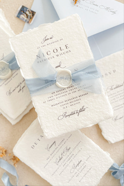 Announce your special day with understated elegance and personal charm. This earthen neutral wedding stationery collection is crafted to celebrate your love story with a refined, organic feel. Each invitation is a personalised handmade invite, featuring your unique details on our premium, artisan paper. The soft, neutral tones create a timeless and tranquil aesthetic, perfectly complemented by the gentle hue of the "Light Sky" accent color.