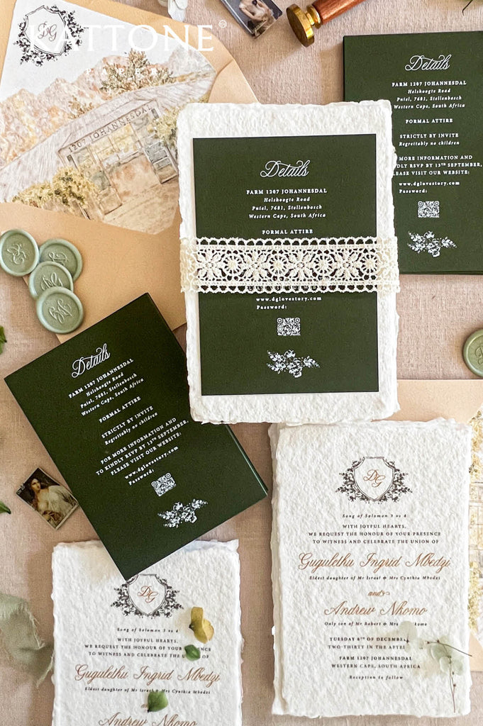 A styled flat-lay of vintage-inspired wedding stationery on a beige surface, including dark green envelopes, white lace-trimmed cards, wax seals, a wax seal stamp, and a wax seal key.
