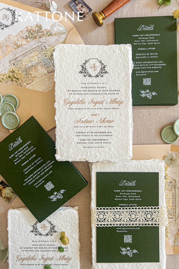 Top-down flat lay of luxury forest green wedding invitation suite featuring ivory handmade deckled-edge paper, botanical monogram crest, dark green details cards, cream lace band, sage green wax seals, beige envelopes, and custom watercolor venue envelope liners styled on a neutral linen background
