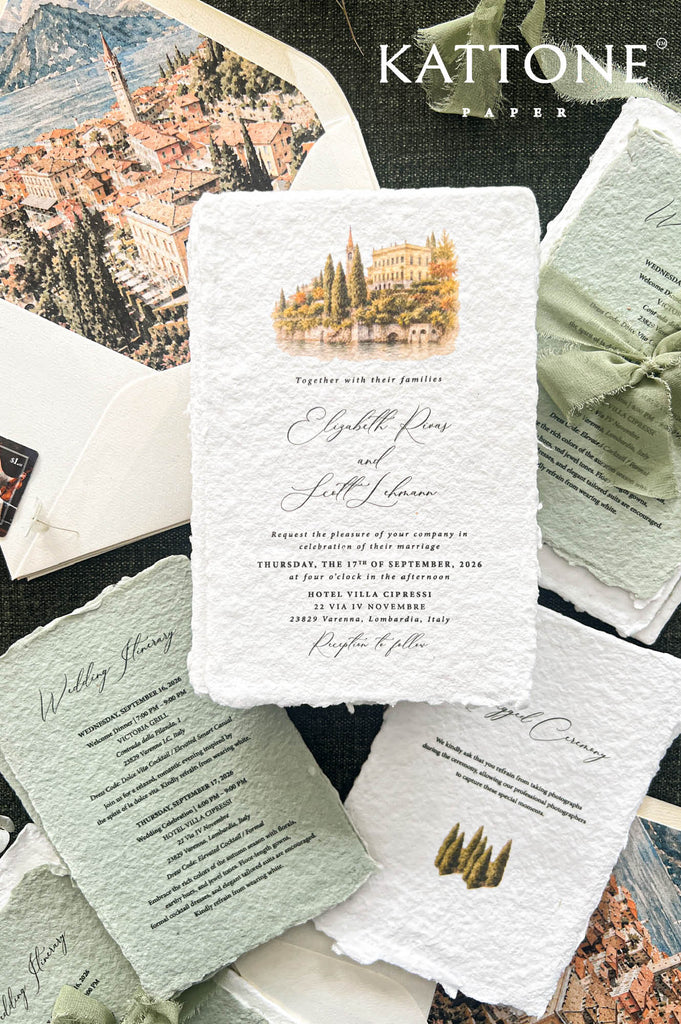 A styled flat-lay of wedding stationery from Kattone Letter, featuring a central white textured paper invitation card with a watercolor villa illustration, surrounded by matching sage green envelopes, folded paper inserts, and a scenic background print.