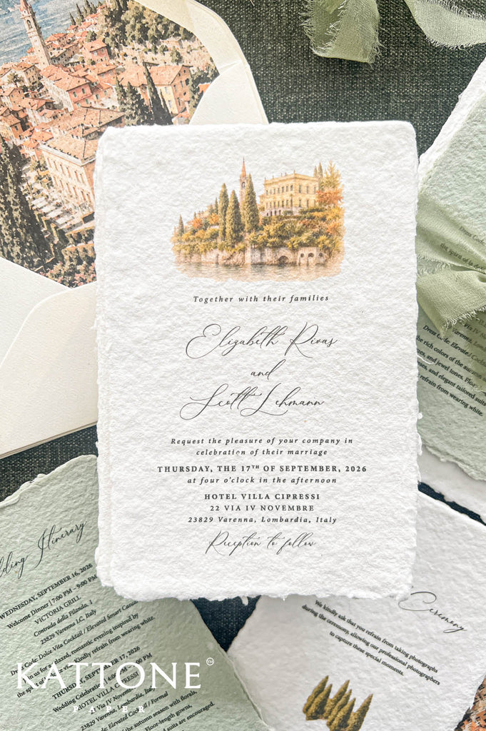 A square white wedding invitation card with a textured, handmade paper look, featuring a watercolor illustration of a historic villa and trees at the top. The card is styled in a flat-lay arrangement with other vintage-style invitation cards, a green leaf, and a dark textured background.