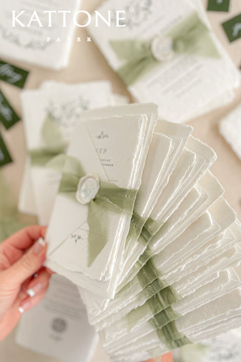 Enhance your special day with our exquisite Wedding Invitations featuring stunning silk ribbons and wax seals. Each invite is crafted on beautiful handmade deckled edge paper, adding a touch of elegance to your celebrations. Our customizable designs ensure that your unique love story shines through. Contact us for a personalized quote.