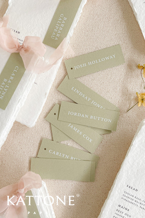 Introduce modern simplicity to your event with our place cards, crafted from premium cardstock in a soft sage color and printed with clean, contemporary typography. Their slim tag-style silhouette offers a fresh, minimalist look perfect for weddings, rehearsal dinners, corporate gatherings, or garden-inspired celebrations. These versatile cards can be displayed on napkins, tied with ribbon, or layered with menus for a refined and cohesive tablescape.