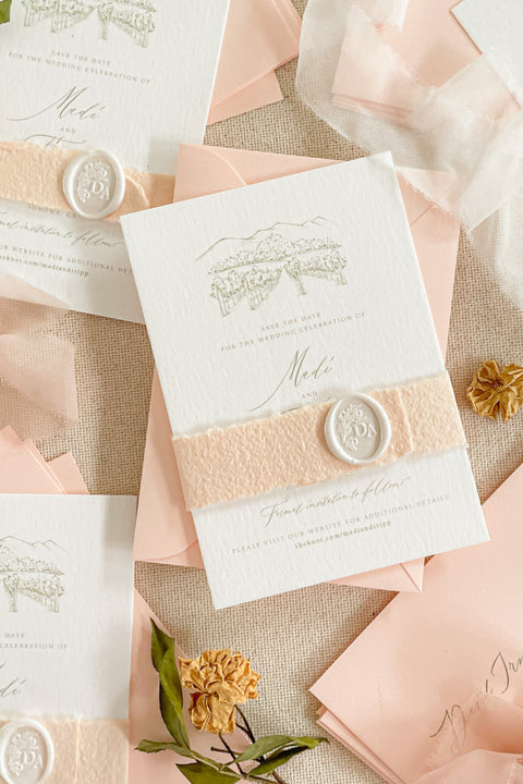 Announce your celebration with timeless elegance through our custom illustrated Save the Date cards, featuring a hand-drawn watercolor or line sketch of your wedding venue. Each card is printed on premium textured cotton paper and paired with soft blush envelopes, vellum wraps, and a white wax seal, creating a refined and romantic presentation.