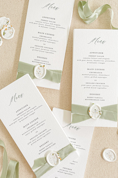 Elevate your reception with our luxury wedding menus, featuring velvet ribbon detailing and elegant wax seals. Crafted on premium textured cardstock with refined typography, these menus exude timeless sophistication and charm. Perfect for romantic, fine-art, and garden weddings, each piece adds an artisanal touch to your tablescape - where design meets elegance.
