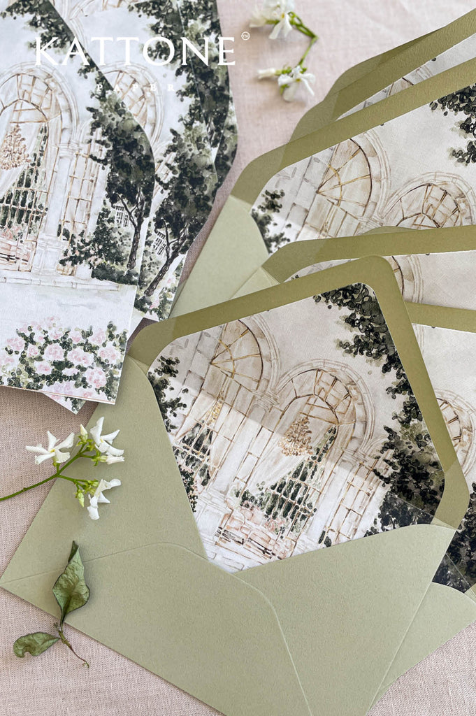 Coordinated wedding envelopes with custom venue illustration liners in a soft green and neutral palette, designed for elegant weddings.