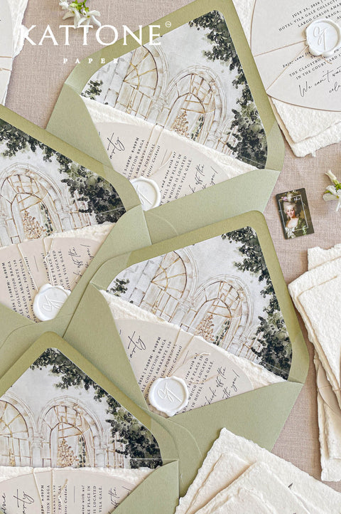 Flat lay of bespoke wedding envelopes with illustrated watercolor venue liners, styled with soft florals for a refined and romantic stationery aesthetic.