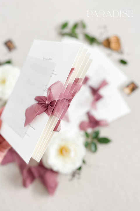 This wedding invitation suite exudes timeless romance and refined modernity, perfect for couples who love soft luxury and intentional design. Wrapped in delicate vellum jackets and tied with rich burgundy silk ribbons, each invitation feels like an elegant love letter - graceful, textured, and unforgettable. Printed on luxury fine art cardstock, the minimalist typography and spacious layout create a beautifully balanced aesthetic that feels both modern and classic.