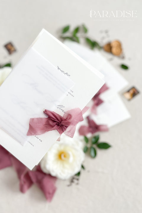 This wedding invitation suite exudes timeless romance and refined modernity, perfect for couples who love soft luxury and intentional design. Wrapped in delicate vellum jackets and tied with rich burgundy silk ribbons, each invitation feels like an elegant love letter - graceful, textured, and unforgettable. Printed on luxury fine art cardstock, the minimalist typography and spacious layout create a beautifully balanced aesthetic that feels both modern and classic.