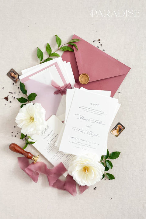 This wedding invitation suite exudes timeless romance and refined modernity, perfect for couples who love soft luxury and intentional design. Wrapped in delicate vellum jackets and tied with rich burgundy silk ribbons, each invitation feels like an elegant love letter - graceful, textured, and unforgettable. Printed on luxury fine art cardstock, the minimalist typography and spacious layout create a beautifully balanced aesthetic that feels both modern and classic.