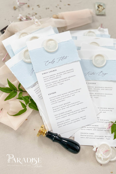 Elevate your table setting with our handmade paper wedding menus with personalized name tags, designed to merge fine-art elegance and functionality. Crafted on luxury cotton paper with a soft deckled edge, each menu features a hand-torn band and custom wax seal that doubles as a keepsake place card. The subtle dusty blue tones add a refined, romantic touch to coastal, garden, or destination weddings.
