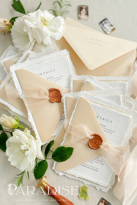 Simple, elegant, and timeless - our handmade wedding invitation suite is crafted from luxury cotton paper with naturally torn deckled edges, giving each piece a soft, organic texture. Paired with beige envelopes, blush silk ribbon, and a classic bronze wax seal, this design captures understated sophistication and effortless romance.
