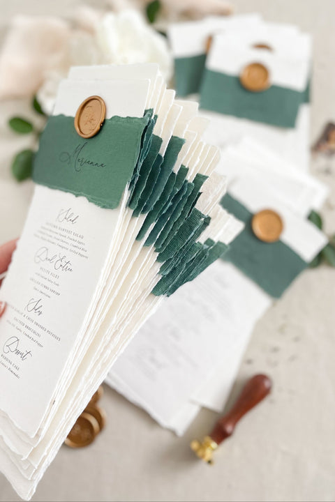 Elevate your wedding tablescape with our luxury handmade wedding menus, featuring deckled edges, silk paper belly bands, and wax seal accents. Each piece is crafted on fine cotton rag paper to create a timeless balance between elegance and texture - perfect for romantic, classic, or fine art celebrations. These menus blend craftsmanship and sophistication, turning every place setting into an unforgettable detail of your special day.