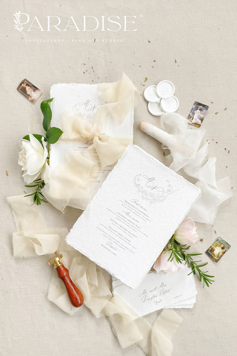 Bring a touch of romantic refinement to your reception with our handmade paper wedding menus, wrapped in soft ivory silk ribbon and finished with an elegant monogram. Each menu is printed on luxury cotton paper with organic deckled edges, embodying effortless sophistication and artisanal charm. Perfect for timeless, fine-art, and garden-inspired weddings. Every detail speaks of craftsmanship, creating an heirloom piece your guests will adore.