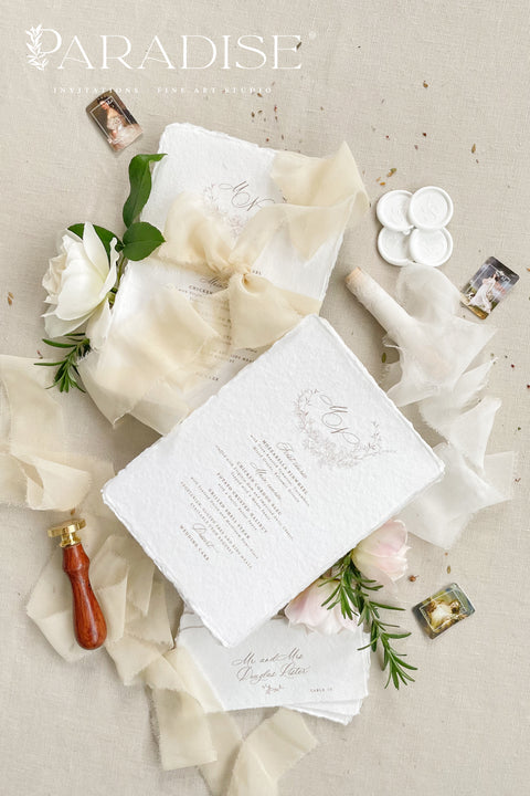 Bring a touch of romantic refinement to your reception with our handmade paper wedding menus, wrapped in soft ivory silk ribbon and finished with an elegant monogram. Each menu is printed on luxury cotton paper with organic deckled edges, embodying effortless sophistication and artisanal charm. Perfect for timeless, fine-art, and garden-inspired weddings. Every detail speaks of craftsmanship, creating an heirloom piece your guests will adore.