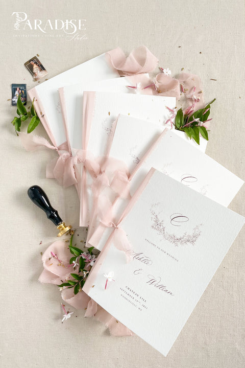 Designed for couples who love soft, feminine details, this wedding program features a gentle blush ribbon, subtle floral artwork, and beautifully balanced typography. The premium paper and delicate monogram create an elevated, cohesive look that enhances your ceremony styling. Thoughtfully crafted to feel both modern and timeless, it offers a graceful introduction to your most meaningful moments.