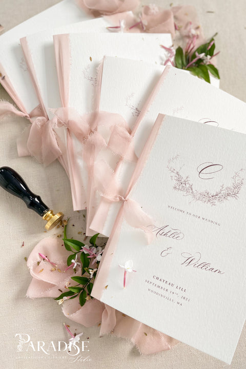 Designed for couples who love soft, feminine details, this wedding program features a gentle blush ribbon, subtle floral artwork, and beautifully balanced typography. The premium paper and delicate monogram create an elevated, cohesive look that enhances your ceremony styling. Thoughtfully crafted to feel both modern and timeless, it offers a graceful introduction to your most meaningful moments.
