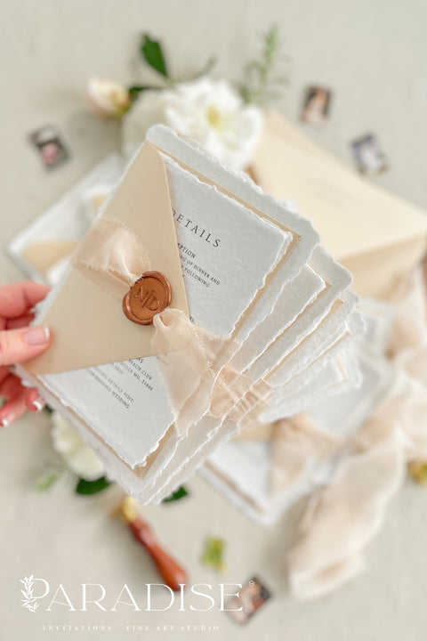 Simple, elegant, and timeless - our handmade wedding invitation suite is crafted from luxury cotton paper with naturally torn deckled edges, giving each piece a soft, organic texture. Paired with beige envelopes, blush silk ribbon, and a classic bronze wax seal, this design captures understated sophistication and effortless romance.