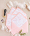 Blush envelopes featuring decorative liners, photographed open to reveal delicate floral patterns for elegant wedding stationery.