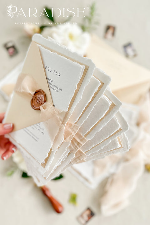 Simple, elegant, and timeless - our handmade wedding invitation suite is crafted from luxury cotton paper with naturally torn deckled edges, giving each piece a soft, organic texture. Paired with beige envelopes, blush silk ribbon, and a classic bronze wax seal, this design captures understated sophistication and effortless romance.