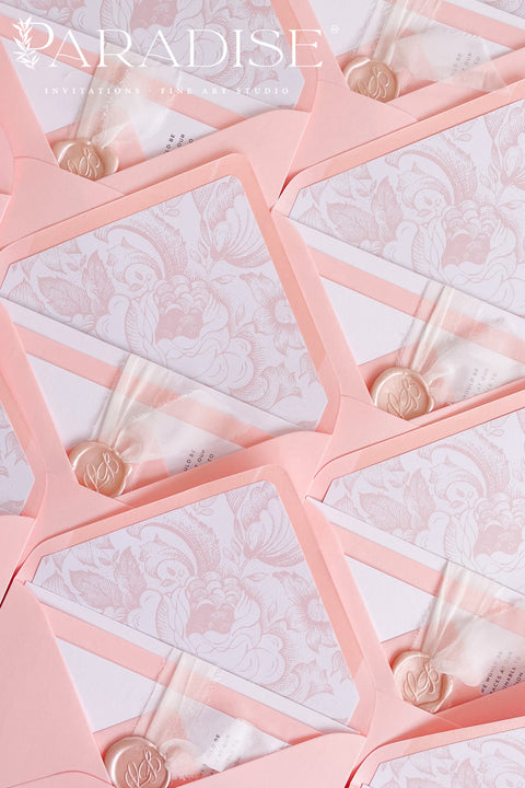 Blush envelopes featuring decorative liners, photographed open to reveal delicate floral patterns for elegant wedding stationery.