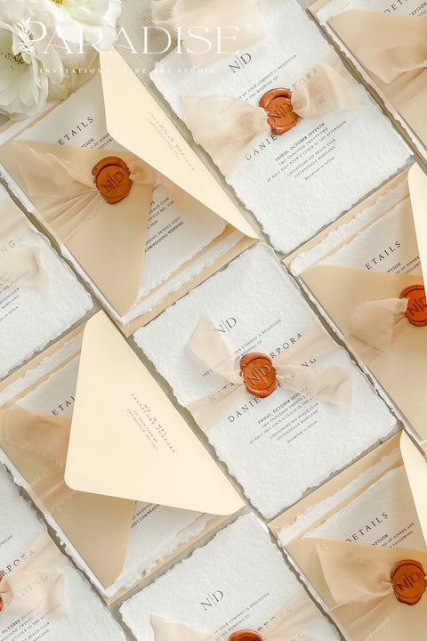 Simple, elegant, and timeless - our handmade wedding invitation suite is crafted from luxury cotton paper with naturally torn deckled edges, giving each piece a soft, organic texture. Paired with beige envelopes, blush silk ribbon, and a classic bronze wax seal, this design captures understated sophistication and effortless romance.