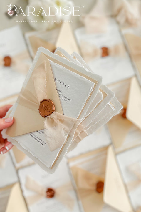 Simple, elegant, and timeless - our handmade wedding invitation suite is crafted from luxury cotton paper with naturally torn deckled edges, giving each piece a soft, organic texture. Paired with beige envelopes, blush silk ribbon, and a classic bronze wax seal, this design captures understated sophistication and effortless romance.
